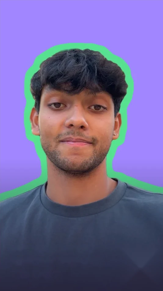 Young man with dark hair in a grey T-shirt